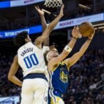 Feb 23, 2025; San Francisco, California, USA; Dallas Mavericks guard Max Christie (00) blocks a shot by Golden State Warriors guard Brandin Podziemski (2) during the fourth quarter at Chase Center. Mandatory Credit: John Hefti-Imagn Images